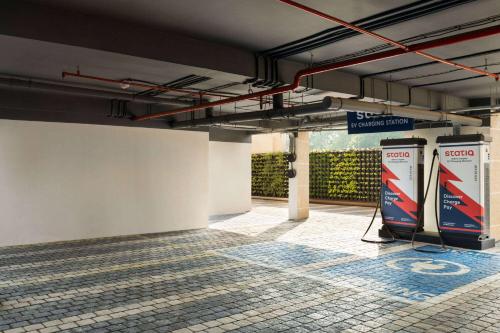 an empty parking garage with a sign on the wall at Ramada Encore by Wyndham Bareilly Civil Lines in Bareilly