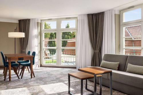 a living room with a couch and a table at Vienna House Easy by Wyndham Castrop-Rauxel in Castrop-Rauxel