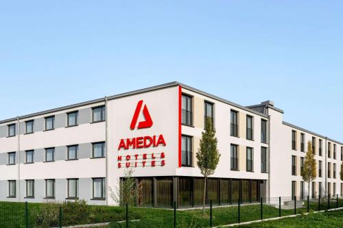 an office building with aania sign on it at Amedia Munich Dachau, Trademark Collection by Wyndham in Dachau