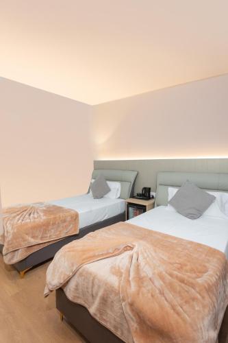two beds in a room with two beds sidx sidx sidx at Hotel Casa Lili in Jávea
