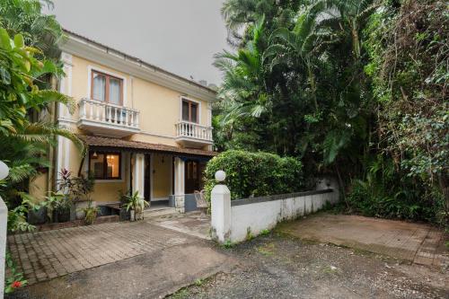 a house with a fence in front of it at The Bumblebee- Serene 3BHK Villa- Candolim, Goa By StayMonkey in Candolim