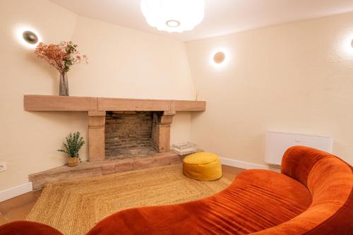 a living room with a couch and a fireplace at Hotel BESTPRICE Santillana in Santillana del Mar