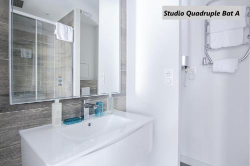 a bathroom with a white sink and a mirror at Apparts de l'Oncle Louis in Versailles