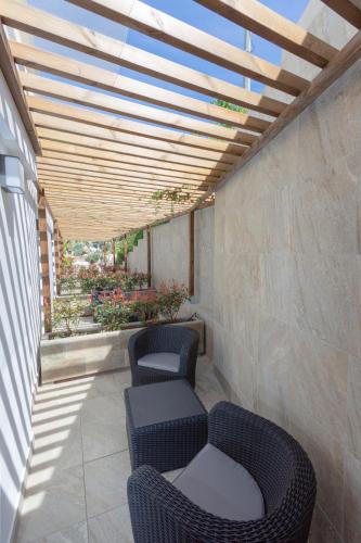 a patio with two chairs and a table and a roof at Hotel Casa Lili in Jávea