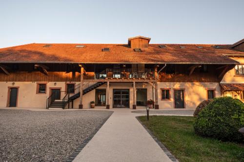 a large building with a walkway in front of it at Hôtel du DOMAINE SAINT LOUP in Michelbach