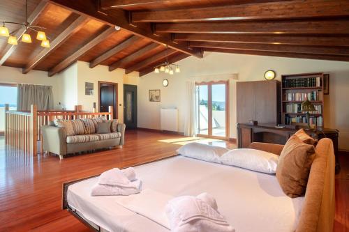 a living room with two couches and a couch at Newly Renovated Villa 4 Seasons with BBQ, private pool, ping pong and football table in Viranepiskopí