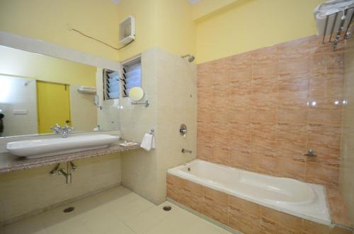 a bathroom with a bath tub and a sink at Aaram Baagh - A Luxury Nature Resort in Udaipur