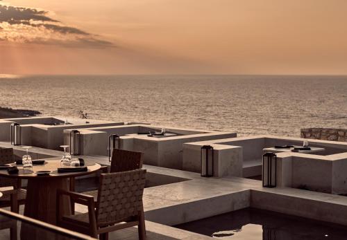 a restaurant with a view of the ocean at The Royal Senses Resort & Spa Crete, Curio Collection by Hilton in Panormos Rethymno