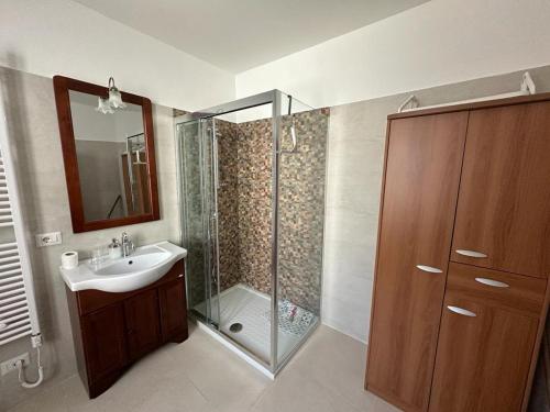 a bathroom with a shower and a sink and a mirror at 7 Cannelle Guest House in Isernia