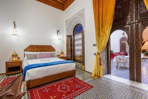 a bedroom with a large bed and a room with a doorway at Palais Nazha Fes - Luxury Lodging in Fez