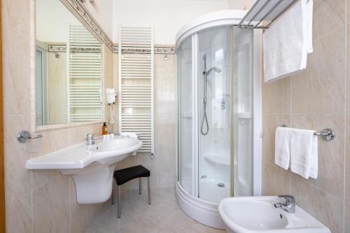 a bathroom with two sinks and a shower at Hotel Vioz in Peio Fonti