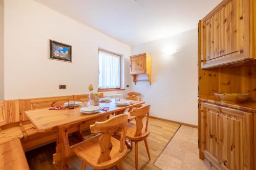 a dining room with a wooden table and chairs at Hotel Vioz in Peio Fonti