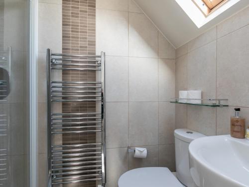 a bathroom with a shower and a toilet and a sink at Pass the Keys Spacious Home in Picturesque Village of Wraysbury in Wraysbury