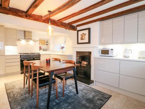 a kitchen with a table and chairs in a room at 36 Main Street in Derby