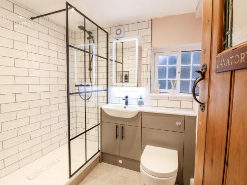 a bathroom with a toilet and a sink and a shower at 36 Main Street in Derby