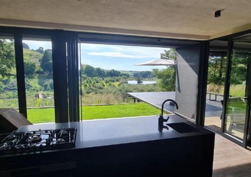 a kitchen with a counter with a view of a yard at Walkersons 96 - NinetySix on Valley View in Dullstroom