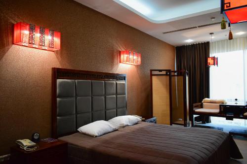 a bedroom with a large bed and red lights at Hotel Feride in Vinnytsya