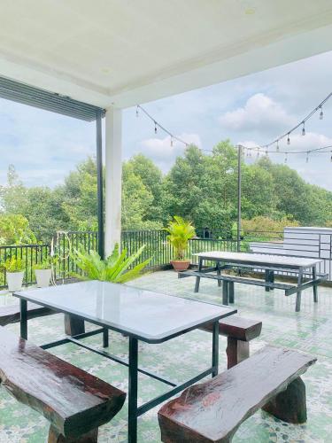 a group of picnic tables and benches on a patio at Homestay KV in Can Tho