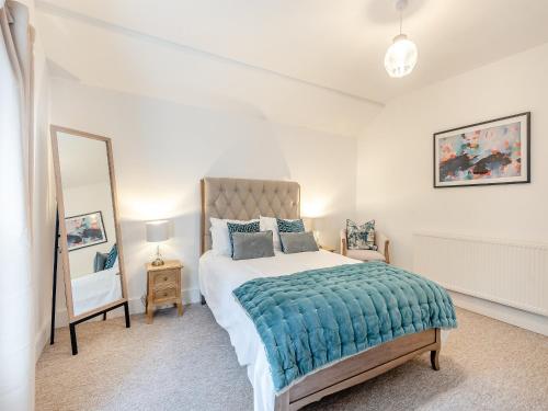 a bedroom with a large bed and a mirror at North Lodge-uk45599 in Southwell