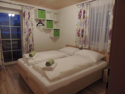a bedroom with a bed with two towels on it at Appartments Rindisplatzl in Schladming