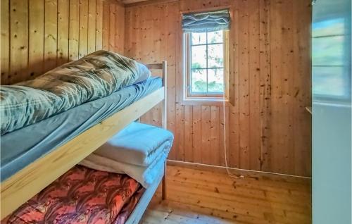 a room with two bunk beds and a window at Cozy Home In Vikes With House Sea View in Vikeså