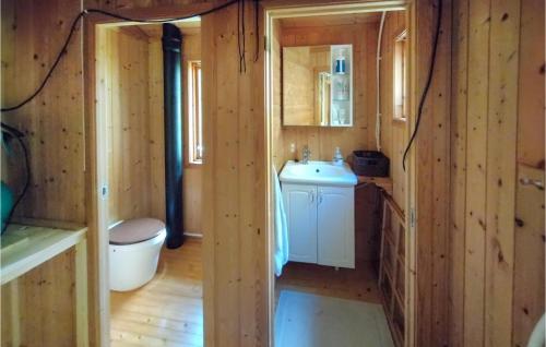 a small bathroom with a toilet and a sink at Cozy Home In Vikes With House Sea View in Vikeså