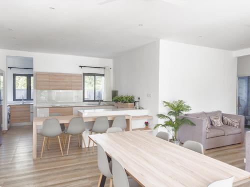a kitchen and living room with a table and chairs at Résidence Coastal View - Privilege Appartement in the heart of Grand-Baie in Grand Baie