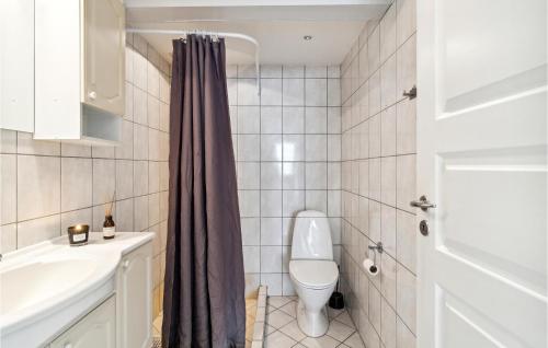 a bathroom with a toilet and a sink at 1 Bedroom Beautiful Apartment In Gilleleje in Gilleleje