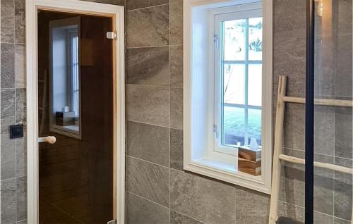 a bathroom with a window and a walk in shower at 5 Bedroom Beautiful Home In Gol in Golsfjellet