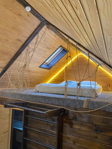 a room with a bed on top of a ceiling at Guest house Shulc in Mizhhirʼʼya