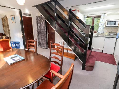 a kitchen and dining room with a table and chairs at Merlins Flight in Hayle