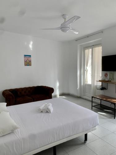a white bedroom with a bed and a couch at Gran Via Experience in Madrid