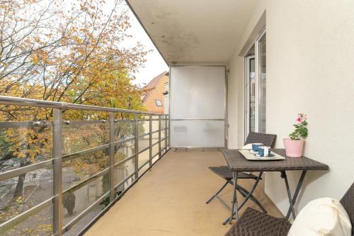 a balcony with a table and chairs and a view at Stylish Studio for 2 with Balcony Robocza Poznań by Renters in Poznań