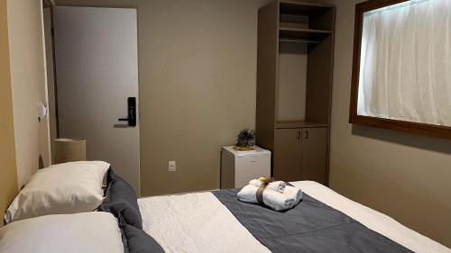 a bedroom with a bed and a window and a mirror at Isla Beach Hotel in Pecém