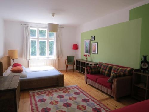 a living room with a bed and a couch at VILLA AM SEE - nähe Berlin in Biesenthal