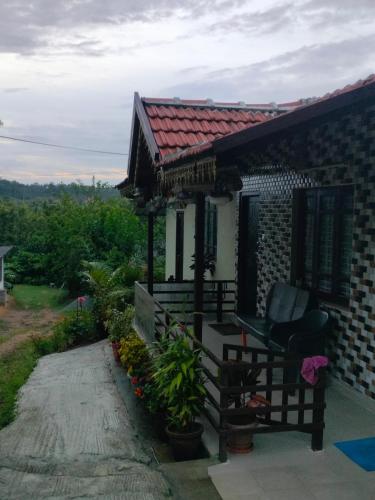 a small house with a bench and a porch at Dreamwood FarmStay in Hassan