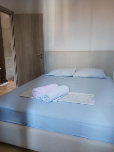 a bed with two towels on top of it at Vagia's Home in Kymi