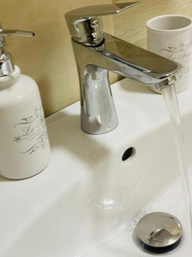 a bathroom sink with a faucet and a toothbrush at Carolina in Alba Iulia