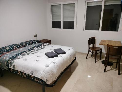 a bedroom with a bed and a table and chairs at Piccadilly Centre Deluxe in Alicante