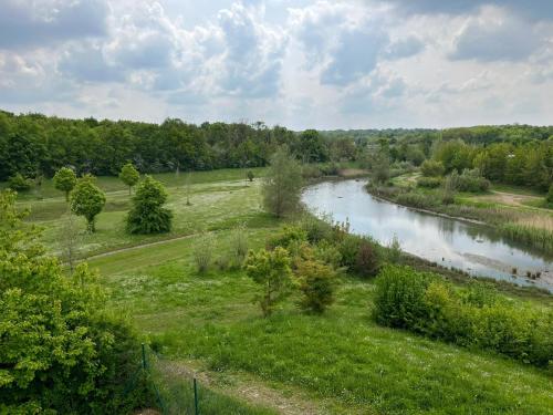 a view of a river with trees and a field at Campanile Melun Sénart in Vert-Saint-Denis