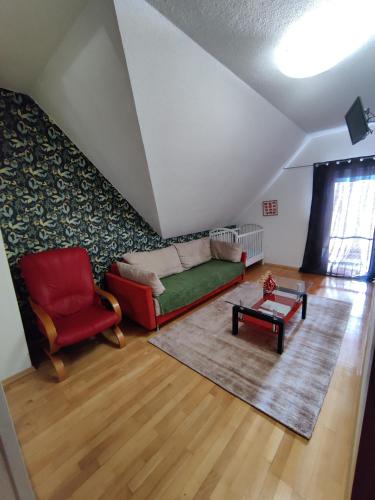 a living room with a couch and a table at Hotel Orlan in Bratislava