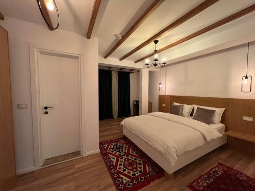 a bedroom with a bed and a door and a rug at Chestnut Hill in Kolgecaj