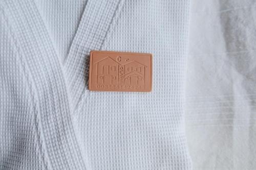a brown button on a white shirt at Holiday House Clavis in Dobrovnik