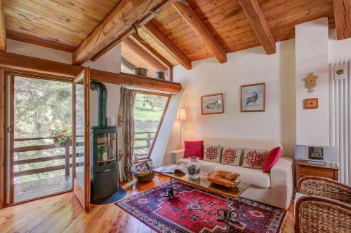 a living room with a couch and a table at Romito Lodge Apartment Mountain Retreat - Happy Rentals in Cesana Torinese