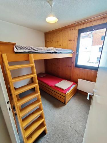 a room with a bunk bed and a ladder at ski-in ski-out 52 in Val Thorens