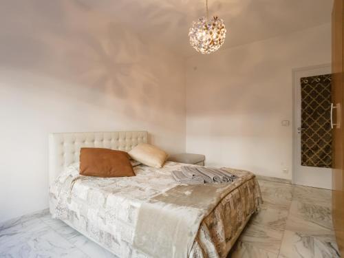 a bedroom with a bed and a chandelier at Baltimore House in Turin