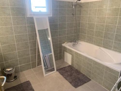 a bathroom with a bath tub and a sink at Maison Barcelonnette, 4 pièces, 7 personnes - FR-1-165A-154 in Barcelonnette