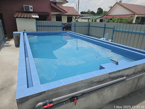 a large swimming pool in a yard at MRI Residence - Homestay in Sg Buloh with Swimming Pool - No Pork&Alcohol Allowed in Bandar Puncak Alam