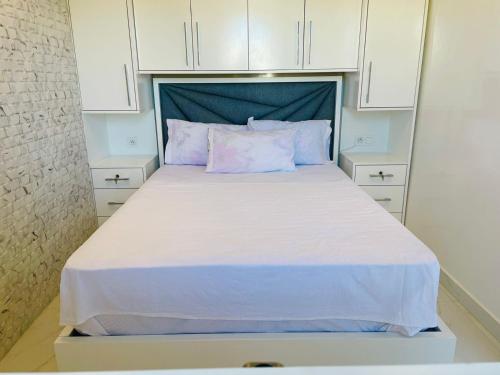 a large bed in a small room with white cabinets at Ksar Rimal par IMMO MARINA Vacances de Rêve J in Marina Smir
