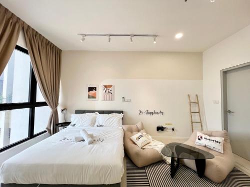 a bedroom with a bed and a table and chairs at HighPark Suites by Sleepy Bear in Petaling Jaya